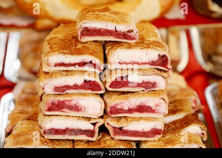 Homemade strudels with  various flavor for sale at christmas market outdoors. Fresh homemade cakes stuffed with various filling. Serving domestic natu Stock Photo