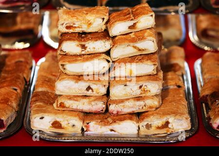 Homemade strudels with  various flavor for sale at christmas market outdoors. Fresh homemade cakes stuffed with various filling. Serving domestic natu Stock Photo