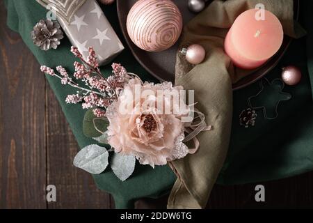 Christmas composition in sail champagne ,green and gray shades, christmas balls and candle, cookie cutters and decorative flower on a green tablecloth Stock Photo