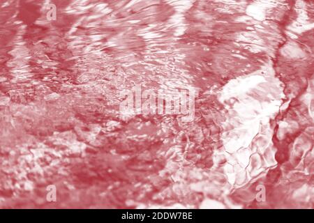 Blurred water river abstract background with waves at surface toned samba red Stock Photo