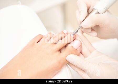 Classic pink wedding toe nail manicure on white backdrop. Spa treatment concept Stock Photo