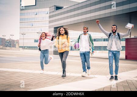 Education, healthcare and pandemic concept - College students wearing medical protective masks for virus and running and happily rejoicing Stock Photo