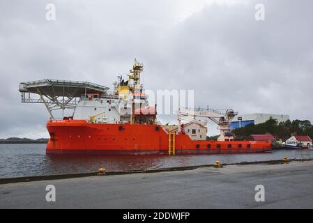 Offshore supply ship Nor Valiant, registered  in Singapore, is seen moored in the harbour at Skudeneshavn, Norway. Stock Photo