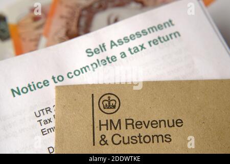 HM Revenue and Customs  (HMRC) letters seen with logos with the brown envelope and blurred self assessment and tax return notice letter. Stock Photo