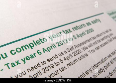 HM Revenue and Customs  (HMRC) letter seen with words 'Complete your tax form'. Blurred tax return notice letter. Authentic documents. SELECTIVE FOCUS Stock Photo