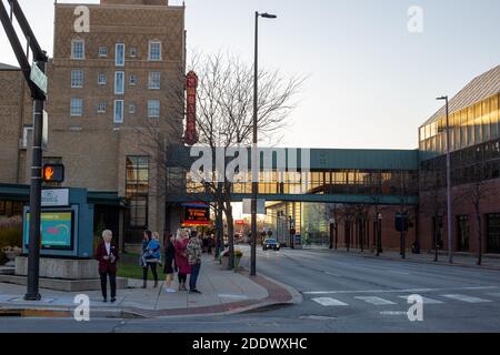 People gather near the skybridge crossing Jefferson Blvd. from the Embassy Theater to the Grand Wayne Center in downtown Fort Wayne, Indiana, USA. Stock Photo