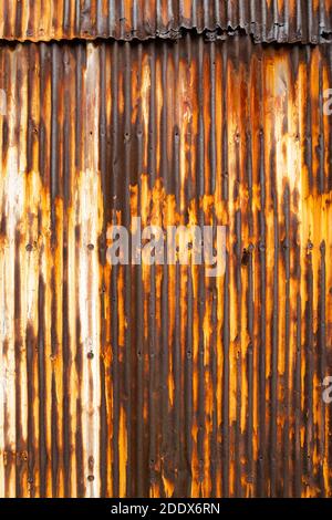 Old rusty wavy metal plate wall background Stock Photo