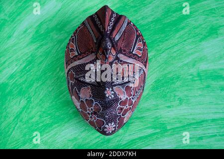 wooden colored african ethnic tribal mask on dark background for wall decoration. Stock Photo