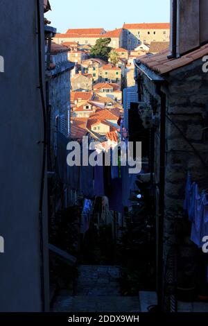 Laundry drying in one of the many narrow streets in the medieval Old town of Dubrovnik, Croatia Stock Photo