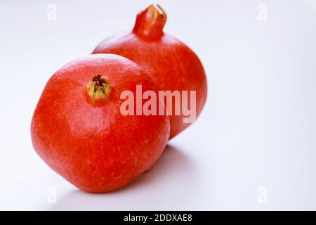 Whole red pomegranate isolated on white background. Close up. Stock Photo