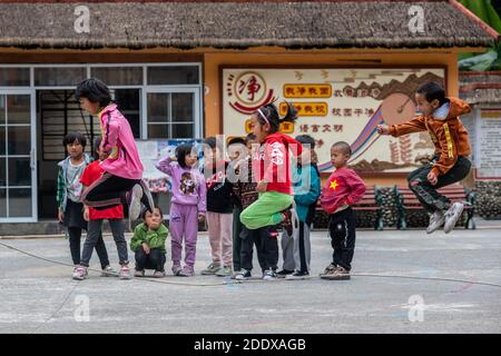 (201127) -- KUNMING, Nov. 27, 2020 (Xinhua) -- Dulong students play rope jumping at Dulongjiang Nine-Year Comprehensive School in Dulongjiang Township of Gongshan Dulong and Nu Autonomous County, southwest China's Yunnan Province, Oct. 31, 2020. Dulong is a mountain-dwelling ethnic group in southwest China. It is one of the least populous of China's 56 minority nationalities. It is also called a 'direct-transition' minority ethnic group because the Dulong people didn't bid farewell to primitive life until the founding of the People's Republic of China in 1949 and since then they directly step Stock Photo