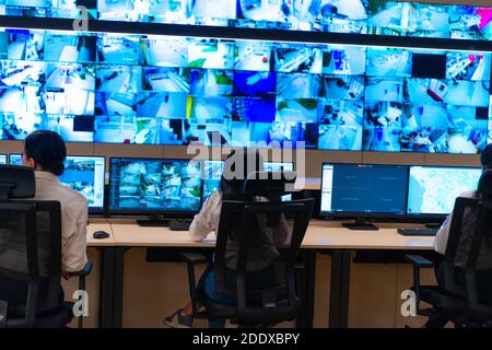 Team of secret agents in uniforms, monitoring cyber, video and communications at the main control data center station. Stock Photo
