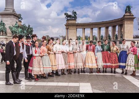 BUDAPEST, HUNGARY, 06 APRIL 2019: Spring celebration parade through the Budapest streets. Folk Dancers in national costumes in the Heroes Square. Phot Stock Photo