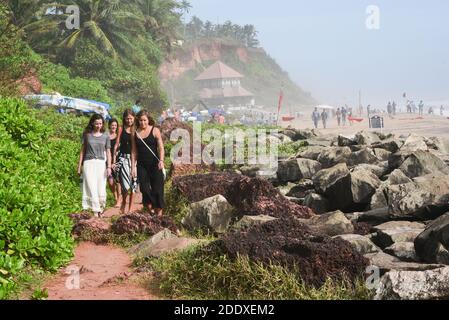 A group of woman female tourist friends enjoying walking by the Kovalam  beach in Kerala Gods own country India Varkala beach seashore, in Trivandrum. Stock Photo