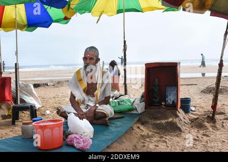 Hindu religious priest doing prayers at Varkala beach Kerala.  Kovalam beach in Kerala Gods own country India Varkala beach seashore, in Trivandrum. Stock Photo