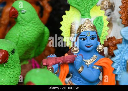Many colorful statue sculptures of Hindu god, lord Krishna in an street shop, Delhi, India. popular Indian divinity worshiped celebrated as Janmashtam Stock Photo