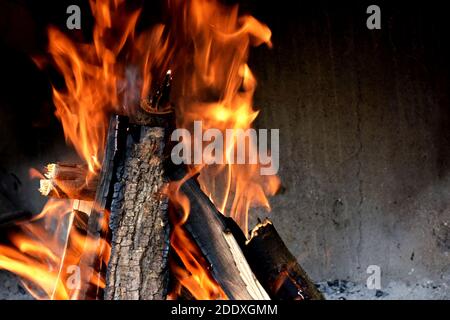Glowing embers in hot red color, abstract background. The hot embers of burning wood log fire. Stock Photo