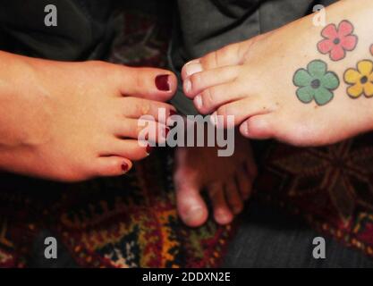 foot of a woman with red painted nails, barefoot in summer Stock Photo
