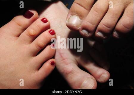 foot of a woman with red painted nails, barefoot in summer Stock Photo