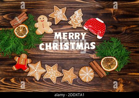 Christmas composition of tasty gingerbread cookies, oranges, fir tree Stock Photo