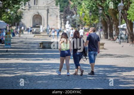 Lamego / Portugal - 07 25 2019 : View of a couple with daughter tourists, walking and looking the downtown city Stock Photo