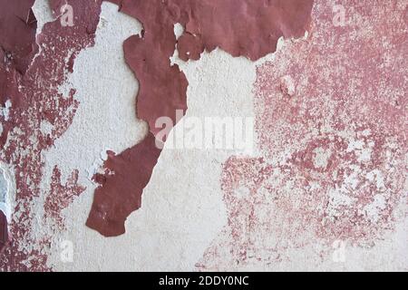 Old weathered burgundy coloured painted wall. Stock Photo