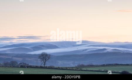 Near Tynygraig, Ceredigion, Wales, UK. 27th November 2020 UK Weather: Cold, calm morning along the countryside lanes of Ceredigion, with a view of the upslope fog rolling over the Cambrian mountains in mid Wales. © Ian Jones/Alamy Live News Stock Photo