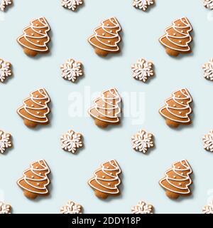 Seamless pattern of decorative cookies in shape of snowflakes and Christmas tree on blue background. Xmas holiday abstract background. Stock Photo