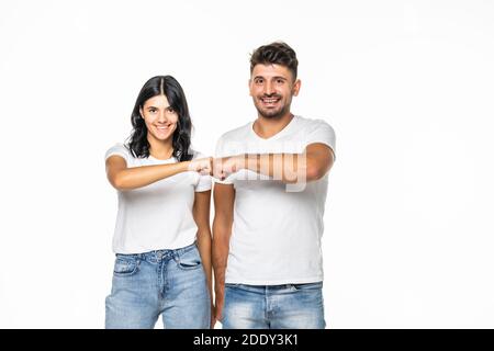 relationships, friendship and people concept - portrait of happy couple in white t-shirts making fist bump gesture over grey background Stock Photo