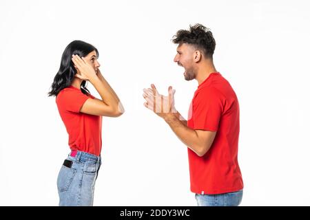Angry couple shouting at each other on white background Stock Photo