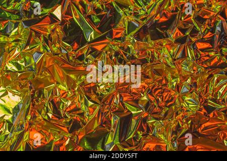 Aluminum background, silver foil metal with uneven and warped shiny surface Stock Photo