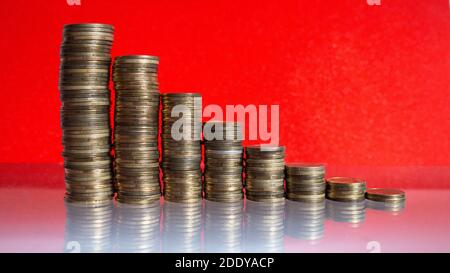 Stacks of coins with decreasing of Interest rates. Stock Photo