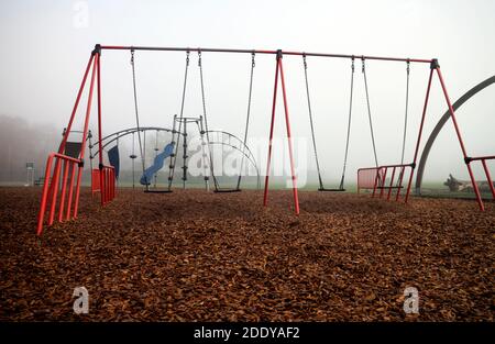 Playground equipment in St. Nicholas Park on a foggy November day, Warwick, Warwickshire, England, UK Stock Photo