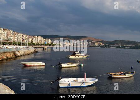 Gemlik dock and marmara sea during sunny day. Groups of small boats are staying on the sea. Stock Photo