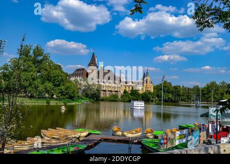 19.06.2012. Budapest, Hungary. Ancient and old type castle and small lake in front of it. Blue sky and small boats. Stock Photo