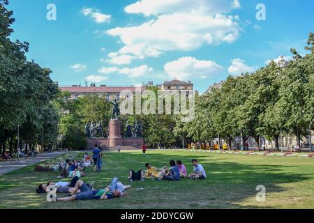 Hungary, Budapest, 21.06.2012. People rest and relaxing on the grass and park behind the parliament building budapest Stock Photo