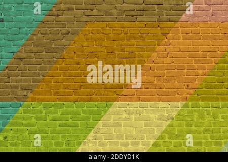 Brick wall painted with multi-colored paints. Abstract background. The old wall. Stock Photo