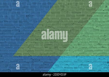 Brick wall painted with multi-colored paints. Abstract background. The old wall. Stock Photo