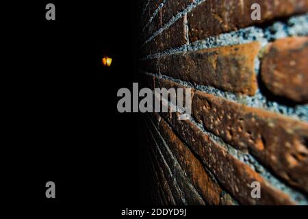 Red bricks and light. Details of red bricks and light is shining from the darkness. Stock Photo