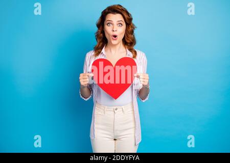 Portrait of her she nice attractive lovely cute pretty glad amazed cheerful wavy-haired girl holding in hands big paper heart isolated on bright vivid Stock Photo