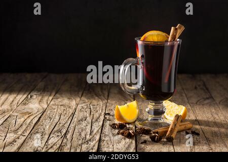 Traditional mulled wine with spices on wooden table Stock Photo