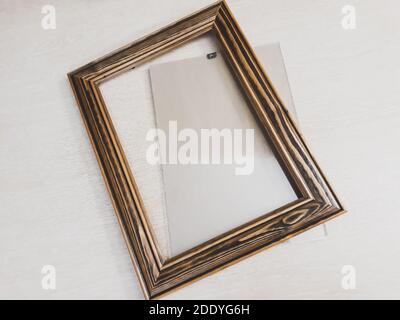 Frame of dark wood for needlework on a light background, horizontal photo Stock Photo