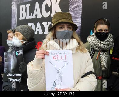 An anti-fur activist wearing a mask holds a placard expressing her opinion during the demonstration.Animal rights activists protested near Ukrainian capital's fur shops to draw attention to the brutality of the fur industry calling to abandon the purchase of fur products during Black Friday sales. The killing of minks in Denmark due to coronavirus may allow an increase in the export of fur from Ukraine and increase products of Ukrainian mink farms in the world fur market up to 10% from the current 1%, as the Association of Fur Breeders believes, reportedly by media. Stock Photo