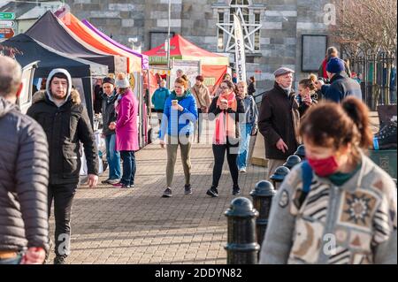 Bantry, West Cork, Ireland. 27th Nov, 2020. After the Met Eireann Yellow Fog Warning lifted late this morning, the sun made an appearance over Bantry Friday Market, which was well attended by both traders and shoppers alike. Credit: AG News/Alamy Live News Stock Photo