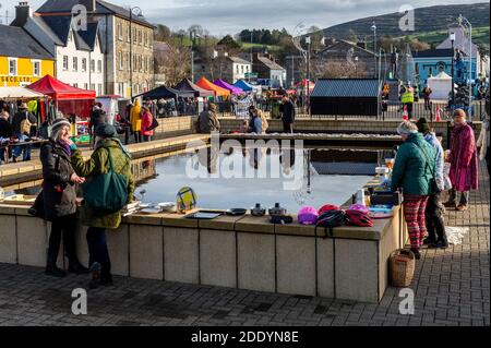 Bantry, West Cork, Ireland. 27th Nov, 2020. After the Met Eireann Yellow Fog Warning lifted late this morning, the sun made an appearance over Bantry Friday Market, which was well attended by both traders and shoppers alike. Credit: AG News/Alamy Live News Stock Photo