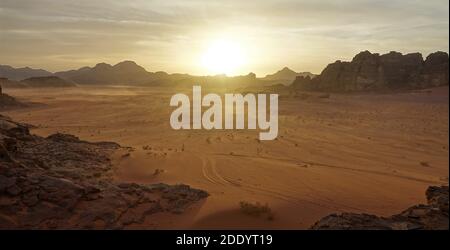 spectacular wadi rum desert at sunset and his jeep tracks during my holiday in the summer of 2018. this is the time for tea in the desert under flares Stock Photo