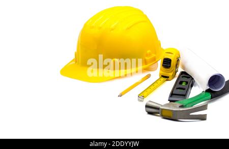 Yellow hard hat with blueprints and pencil,tape measure,hammer,construction bubble level isolated on white background,Copy space,with clipping Path Stock Photo