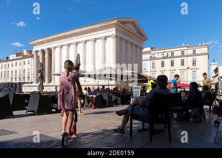 Nimes (south-eastern France): the Roman temple “Maison Carree” (Square House) viewed from the terrace of the “Ciel de Nimes” restaurant. Atmosphere on Stock Photo