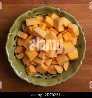 Ceramic plate with pumpkin dice on wooden table Stock Photo