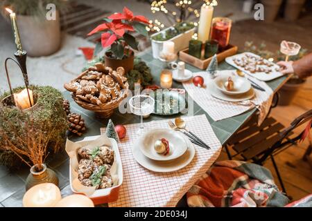 Beautifully decorated dinner table on the terrace outdoors during the New Year holidays Stock Photo